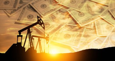 Oil price cap concept. Petroleum, petrodollar and crude oil concept. Oil pump on background of US dollars. Dollars and oil pumps