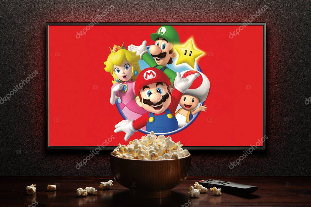 TV screen playing The Super Mario Bros. Movie trailer or movie. TV with remote control and popcorn bowl. Astana, Kazakhstan - March 23, 2023.