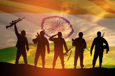 Silhouettes of soldiers on a background of India flag and the sunset or the sunrise. Greeting card for Independence day, Republic Day. India celebration.