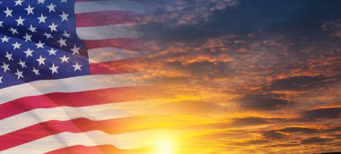United States of America flag on sky at sunset or sunrise background. Independence day, Memorial day, Veterans day. Banner.
