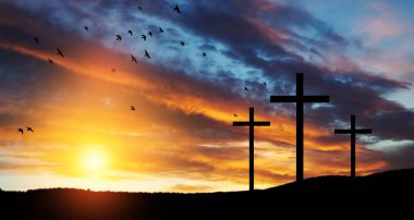 Christian cross on hill outdoors at sunrise. Resurrection of Jesus. Concept photo.