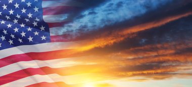 United States of America flag on sky at sunset or sunrise background. Independence day, Memorial day, Veterans day. Banner.