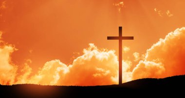 Christian cross on hill outdoors at sunrise. Resurrection of Jesus. Concept photo.