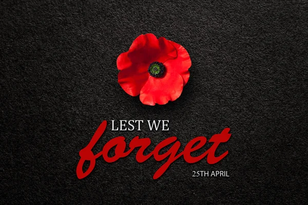 stock image The remembrance poppy - poppy appeal. Poppy flower on black textured background with text. Decorative flower for Anzac Day in New Zealand, Australia, Canada and Great Britain.
