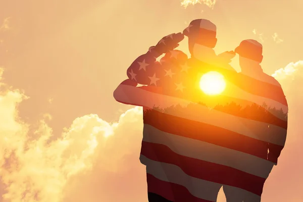 stock image Silhouettes of soldiers with print of sunset and USA flag saluting on a background of light sky. Greeting card for Veterans Day, Memorial Day, Independence Day. America celebration.