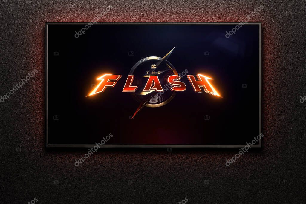 TV screen playing The Flash trailer or movie. TV on black textured wall. Astana, Kazakhstan - May 15, 2023.