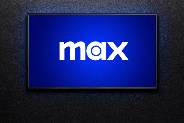 stock image Max or HBO Max logo on TV screen. TV on black textured wall. HBO Max is an American subscription video on-demand streaming service. Astana, Kazakhstan - July 21, 2023.