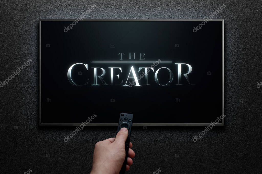 The Creator trailer or movie on TV screen. Man turns on TV with remote control. Astana, Kazakhstan - September 8, 2023.