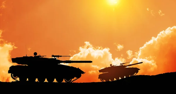 Silhouettes of army tanks at sunset sky background. Military machinery.