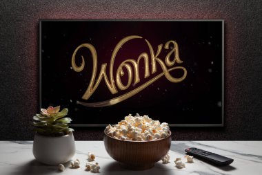 Wonka karavanı ya da TV ekranındaki film. Uzaktan kumandalı televizyon, patlamış mısır kasesi ve ev bitkisi. Astana, Kazakistan - 28 Ekim 2023.