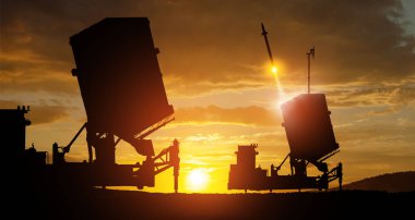 Israel's Iron Dome air defense missile launches. The missiles are aimed at the sky at sunset. Missile defense, a system of salvo fire. clipart