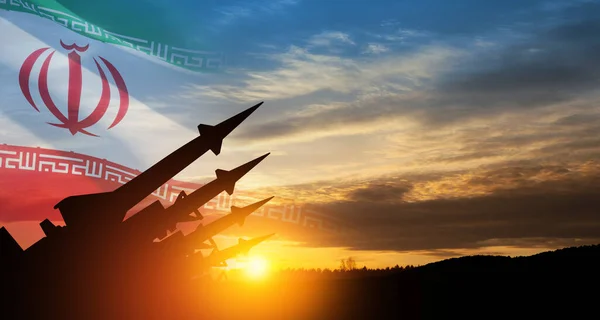 stock image The missiles are aimed at the sky at sunset with Iran flag. Bomb, chemical weapons, missile defense, a system of salvo fire.