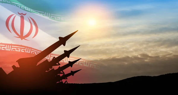 Stock image The missiles are aimed at the sky at sunset with Iran flag. Bomb, chemical weapons, missile defense, a system of salvo fire.