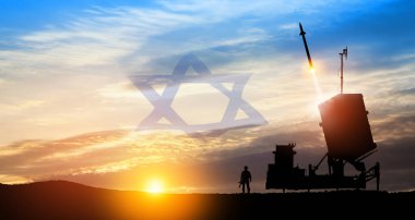 Israel's Iron Dome air defense missile launches. Silhouettes of soldier and Israel's Iron Dome air defense. The missiles are aimed at the sky at sunset with Israel flag. Missile defense. clipart