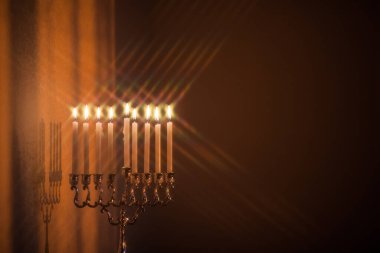 Hanuka menorası ya da gün batımında gün batımında Yahudi bayramı için gün ışığında Hanukkiah. Hanuka lambası, dokuz dallı şamdan, yıldız filtresiyle yanan mumlar..