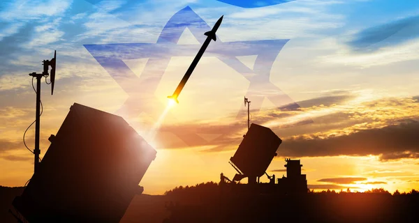 stock image Closeup of Israel's Iron Dome air defense missile launches. The missiles are aimed at the sky at sunset with Israel flag. Missile defense, a system of salvo fire.