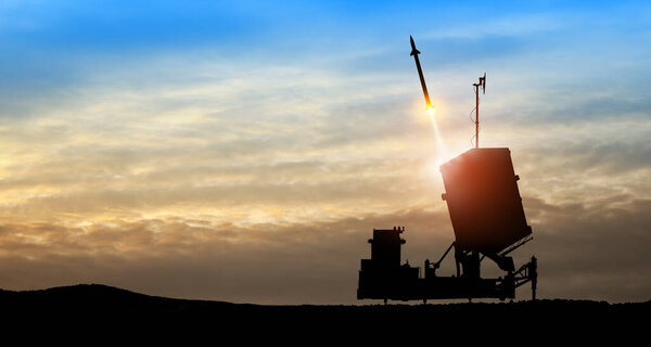 Israel's Iron Dome air defense missile launches. The missiles are aimed at the sky at sunset. Missile defense, a system of salvo fire.