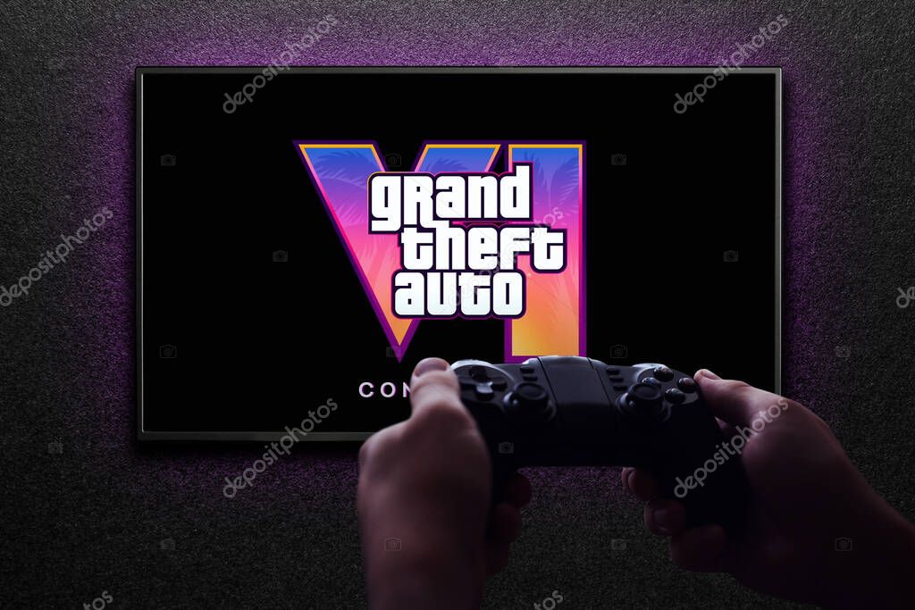 Grand Theft Auto 6 trailer game on TV screen with gamepad in hand on black textured wall with light. Astana, Kazakhstan - December 5, 2023.