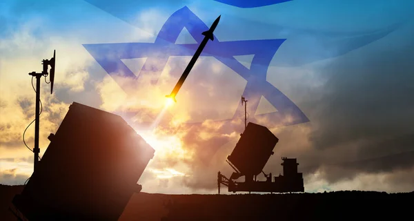 stock image Closeup of Israel's Iron Dome air defense missile launches. The missiles are aimed at the sky at sunset with Israel flag. Missile defense, a system of salvo fire.