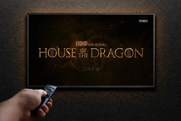 stock image American fantasy drama TV series House of the Dragon trailer or movie on TV screen. Man turns on TV with remote control. Astana, Kazakhstan - July 4, 2024.