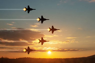 Air Force Day. Aircraft silhouettes on background of sunset. Combat flight of interceptors on a mission.