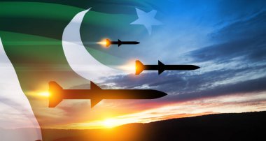 Füzeler hedefe doğru uçuyor. Füzeler gün batımında Pakistan bayrağıyla gökyüzünde. Füze savunması, yaylım ateşi sistemi..