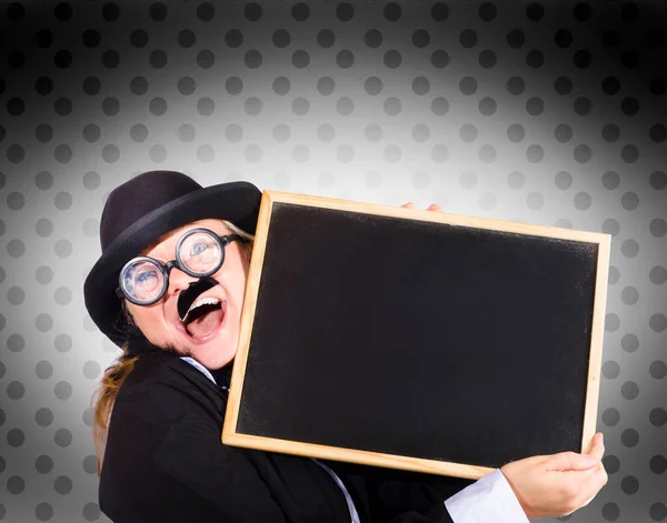 Funny portrait of a female teacher cuddling blank blackboard to show science and math tutoring fun
