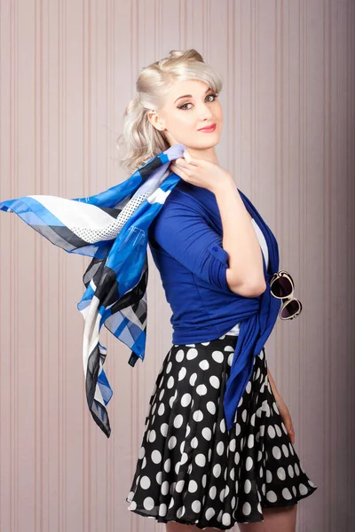 American style pin-up girl strolling with classic hairstyle and makeup on vintage stripe background
