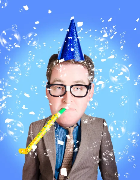 Comical dad in geek glasses celebrating fathers day in birthday party hat with whistle. Dad jokes