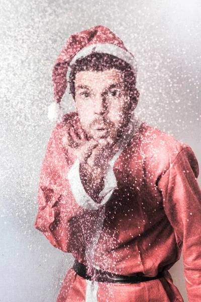 Abstract blurred portrait of Santas little helper blowing magical snow dust in a Christmas miracle conceptual
