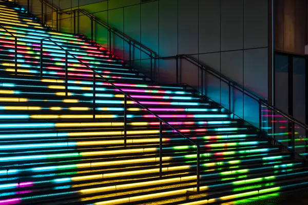 stock image A vibrant, illuminated staircase in Tokyo, Japan, multicolored LED lights,artistic nighttime scene. 