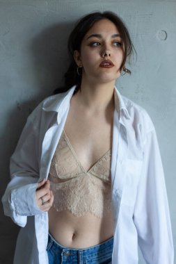 Şeffaf bluzla poz veren seksi genç kadın..