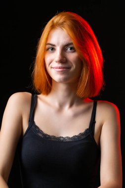 Hoş kızıl saçlı kız, siyah arka planda stüdyo resmi..