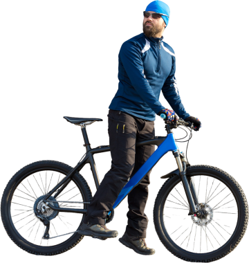 Bir Vintage tuğla beton duvar bir hava süspansiyon çatal ile modern bir dağ Karbon bisiklet üzerinde spor giyim sürme bir adam.