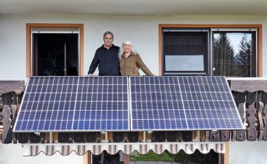 A woman and her husband are happy about the new balcony power plant clipart