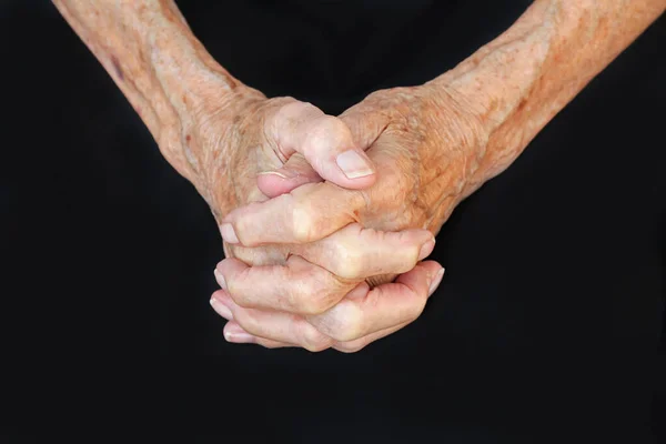 The hands of a praying old woman