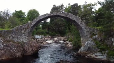 Carrbridge 'deki yük beygiri köprüsünün insansız hava aracı videosu İskoç İskoçya' sındaki en eski taş köprüdür.