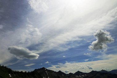 Interesting cloudy mood over the mountain peaks of Austria clipart