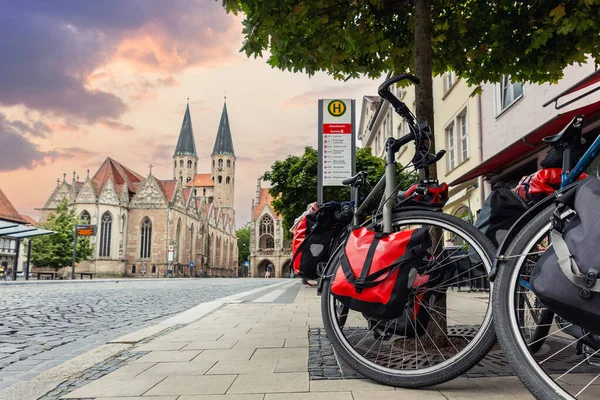 Braunschweig old market square cathedral church modern bikes travel luggage bag equipment parked european city center street. Healthy eco sustainable tourism family trip. Bike hobby adventure tour.