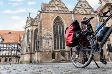Braunschweig eski pazar katedrali kilise modern bisikletler valiz çantası ekipmanları Avrupa şehir merkezi caddesinde park edilmiş. Sağlıklı ekolojik sürdürülebilir turizm aile gezisi. Bisiklet hobisi macera turu.