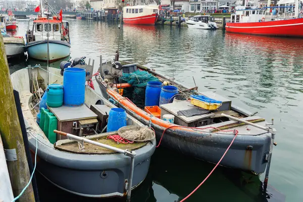 stock image Traditional old german fishing boats net barrel moored Alter Strom Canal Warnemunde harbor fishing market Northern Germany. Commercial fish crab shrimp trawler beam trawl nets  small port city.