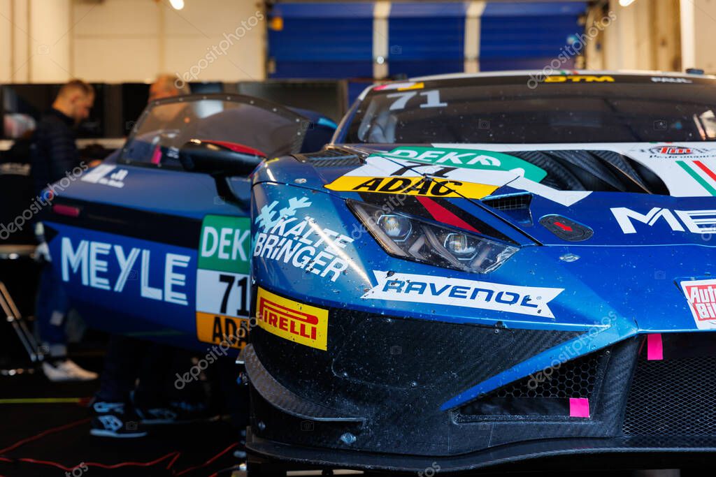 Oschersleben, Germany. 27th April, 2025. Scenic front view LAMBORGHINI HURACAN GT3 EVO 2 GT Masters hood Motorsport Arena race track garage paddock box. European motors auto sport competition.