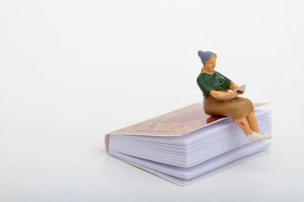 Miniature Figurine Senior Woman Sitting Giant Book Reading — Stock Photo, Image