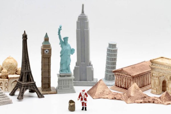 miniature figurine of Santa Claus visiting the main city landmarks of the world
