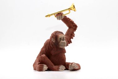 a toy monkey on a white background with a trumpet clipart