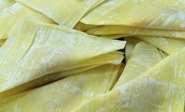 Fresh Wonton Wrappers Filled with Marinated Pork, Ready to be Deep Fried. A Delicious and Popular Snack in Chinese Cuisine.