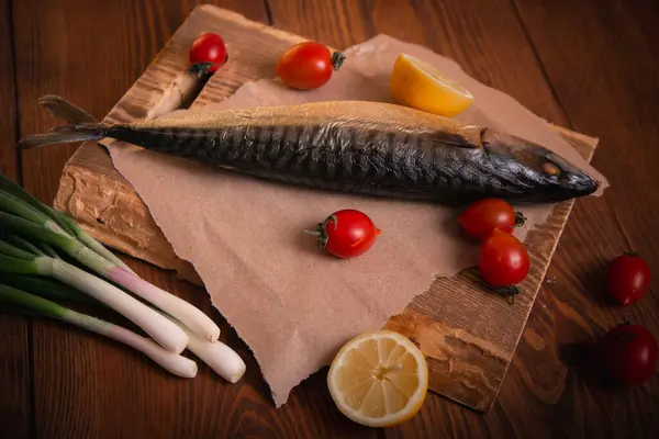 Mackerel on the table with vegetables. Home cooking, fish menu. Studio photo.