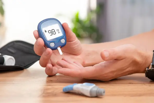 Diabetes doing sugar blood test, using glucometer