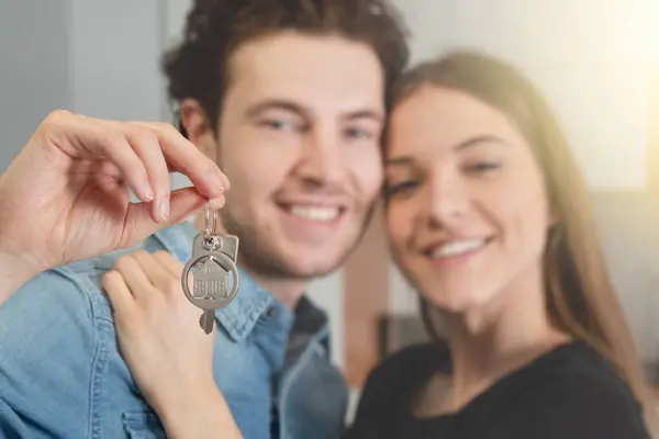 Couple bought their apartment, they hold the keys to the house in their hands