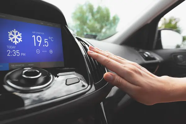 Air conditioning in the car. Cold air.. Driver hand tuning air ventilation grille